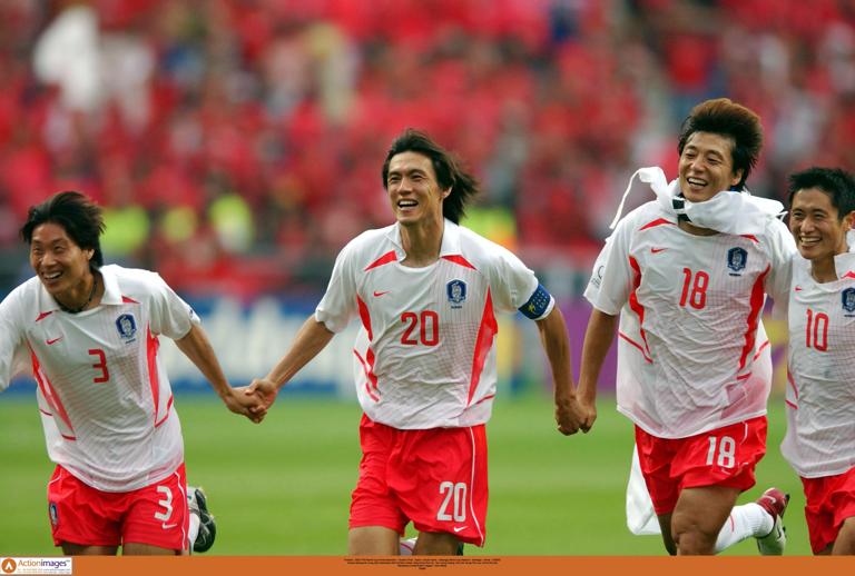 Football - 2002 FIFA World Cup Korea/Japan(tm) - Quarter Final - Spain v South Korea - Gwangju World Cup Stadium - Gwangju - Korea - 22/6/02.Korea's Myung Bo Hong (20) celebrates with his team mates Yong Sung Choi (3) , Sun Hong Hwang (18) and Young Pyo Lee (10) at the end.Mandatory Credit:Action Images / John Sibley.Digital..