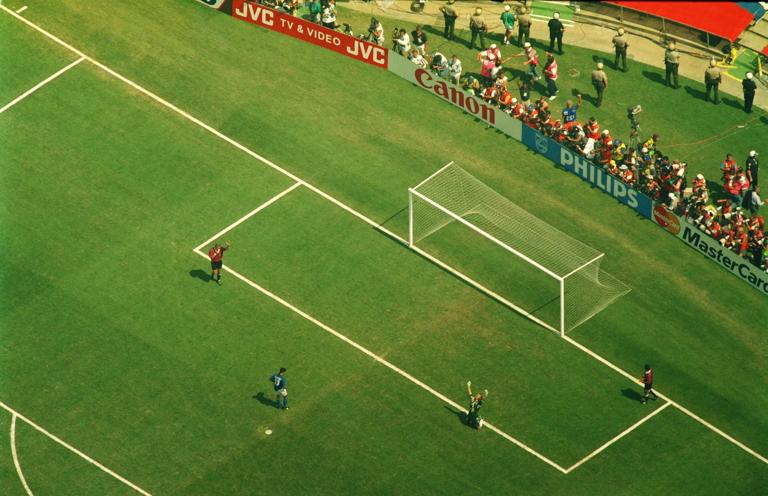 17 jun 1994: roberto baggio (in blue) misses the decisive penalty as brazilian goalkeeper claudio taffarel falls to his knees and raises his arms in victory as brazil wins the 1994 world cup final. Brazil won during a penaly shoot-out at the Rose Bowl stadium in Pasedena. (Photo by Mike Powell/Getty Images)